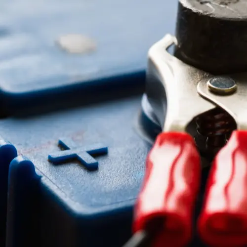 A jumper cable connected to a positive battery terminal